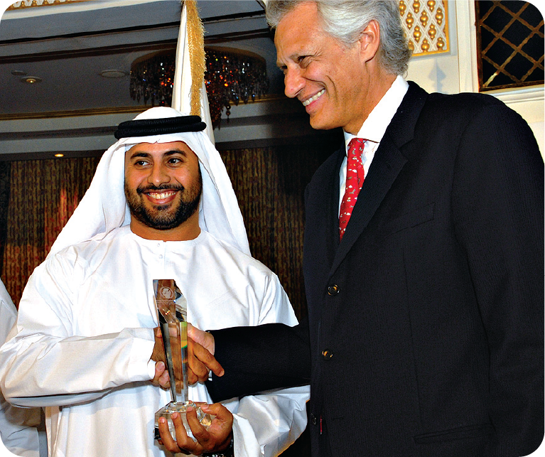Honouree receiving a crystal award from a distinguished guest